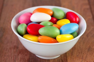 sweets in white bowl on dark background