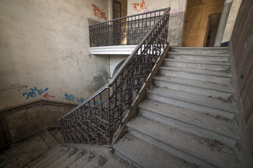 Internal staircase in old abandoned mansion