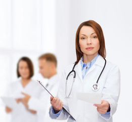 calm female doctor with clipboard