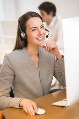 Beautiful Businesswoman in the office on the phone, headset