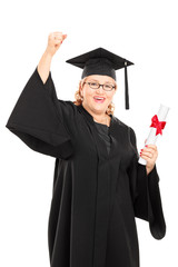 Mature student holding a diploma and gesturing happiness