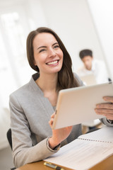 Pretty Business woman with tablet pc computer in office