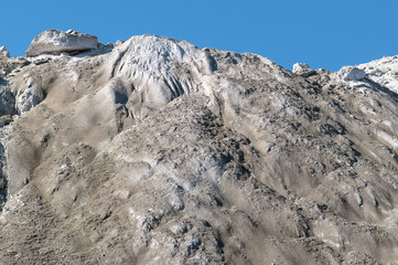 The limestone hillside on the background of blue sky