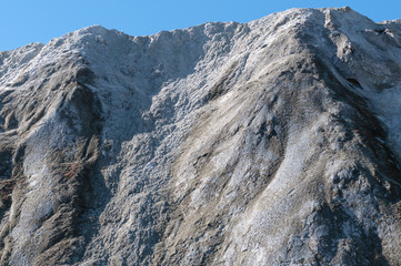 The limestone hillside on the background of blue sky