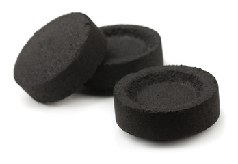 Three charcoal briquettes