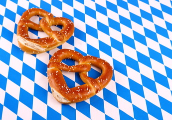 Two pretzel in heart shape on white blue background