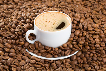 Cup in coffee beans