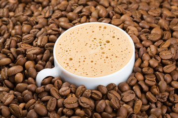 Cup in coffee beans