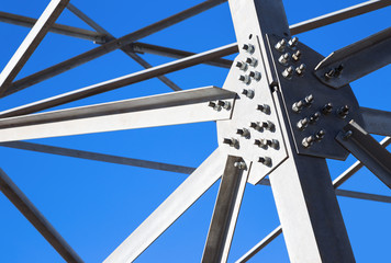 Steel beams against the blue sky. Fragment metal framework.