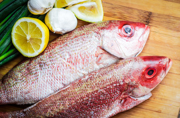 Fresh red snapper preparation with lemon and vegetables