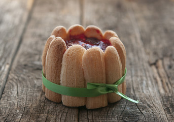 cupcake with strawberries on vintage wooden background