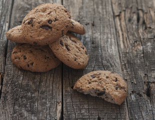 Oatmeal cookies with raisins on vintage wooden background