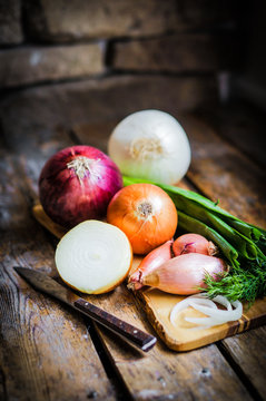 colorful onions on rustic wooden background