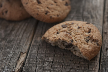 Oatmeal cookies with raisins on vintage wooden background