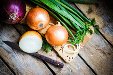 colorful onions on rustic wooden background