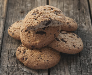 Oatmeal cookies with raisins on vintage wooden background