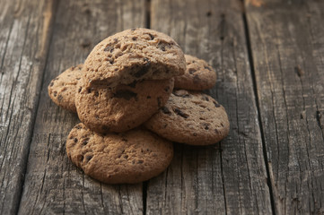 Oatmeal cookies with raisins on vintage wooden background