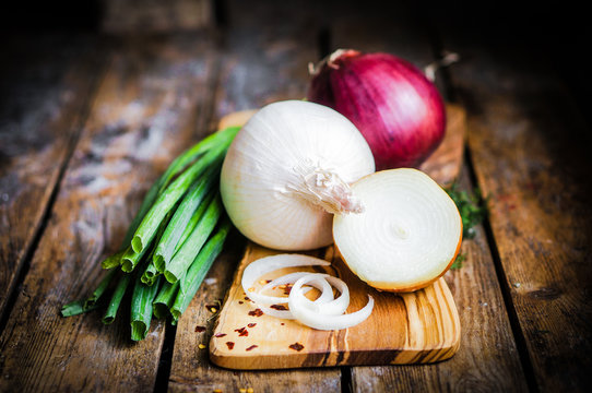 colorful onions on rustic wooden background