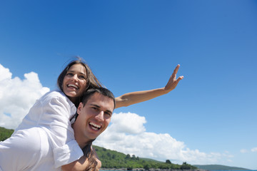 happy couple have fun on the beach