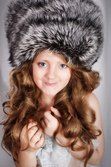 portrait of a beautiful young girl in fur cap