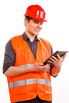 Man Worker In Safety Vest And Hard Hat Using Tablet