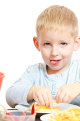 childhood. Boy child kid eating peeled apple fruit. At home.