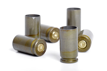 Empty 9mm bullet casings over white background