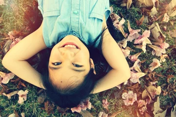 Foto op Plexiglas Little cute Asian child laying down on the flower © RedcupStudio