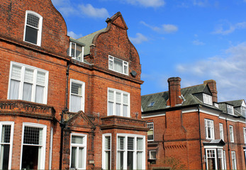 Row of red brick houses in street