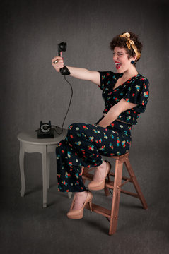 Pinup Girl in Flowered Outfit Excited with Phone Information