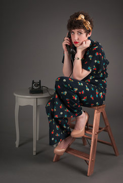 Pinup Girl in Flowered Outfit Ultra Bored on the Telephone