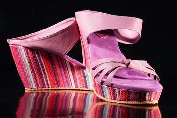 fancy shoes in rainbow colors on isolated black background
