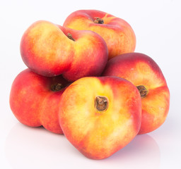 flat peaches (donut peaches) on a background
