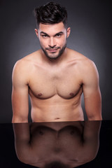 Fototapeta premium naked young man at his desk