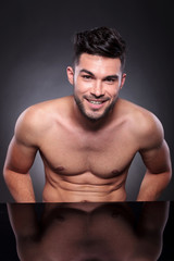 Fototapeta na wymiar young man with bare chest smiles at you