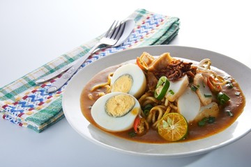 Malaysia favorite spicy noodle mee rebus with fish cake egg