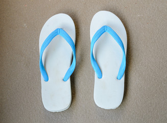 A pair of white slippers beach