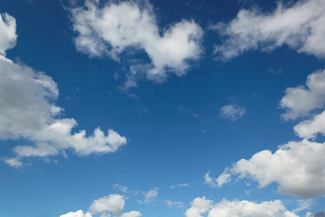 Blue sky with white cumulus clouds.