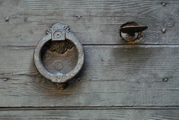 Old knocker on a wooden door