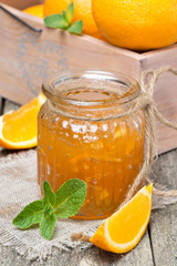 orange marmalade in a glass jar, vertical