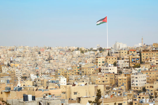 Amman city view with big Jordan flag