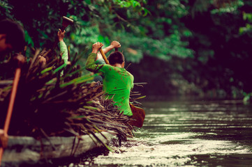 Canoes in the Yasuni national park Ecuador, carring straw plant