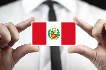 Businessman holding business card with Peru Flag - obrazy, fototapety, plakaty
