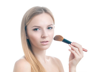 Beauty photo of girl with makeup brush.