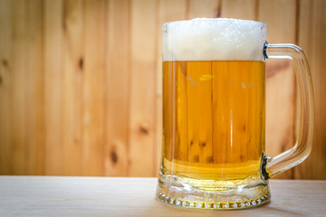 Beer mug on the wooden background