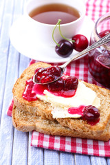 Delicious toast with jam on table close-up