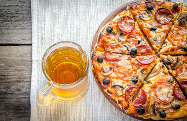 Homemade pizza with a glass of beer