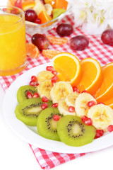 Sweet fresh fruits on plate on table close-up