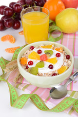 Delicious oatmeal with fruit in bowl on table close-up
