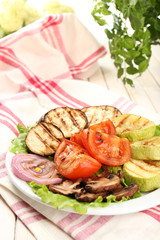 Delicious grilled vegetables on plate on table close-up